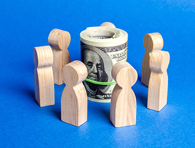 Figures of people surround a bundle of money 
